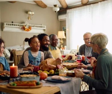 Family sitting around holiday table eating food together