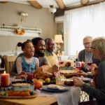 Family sitting around holiday table eating food together