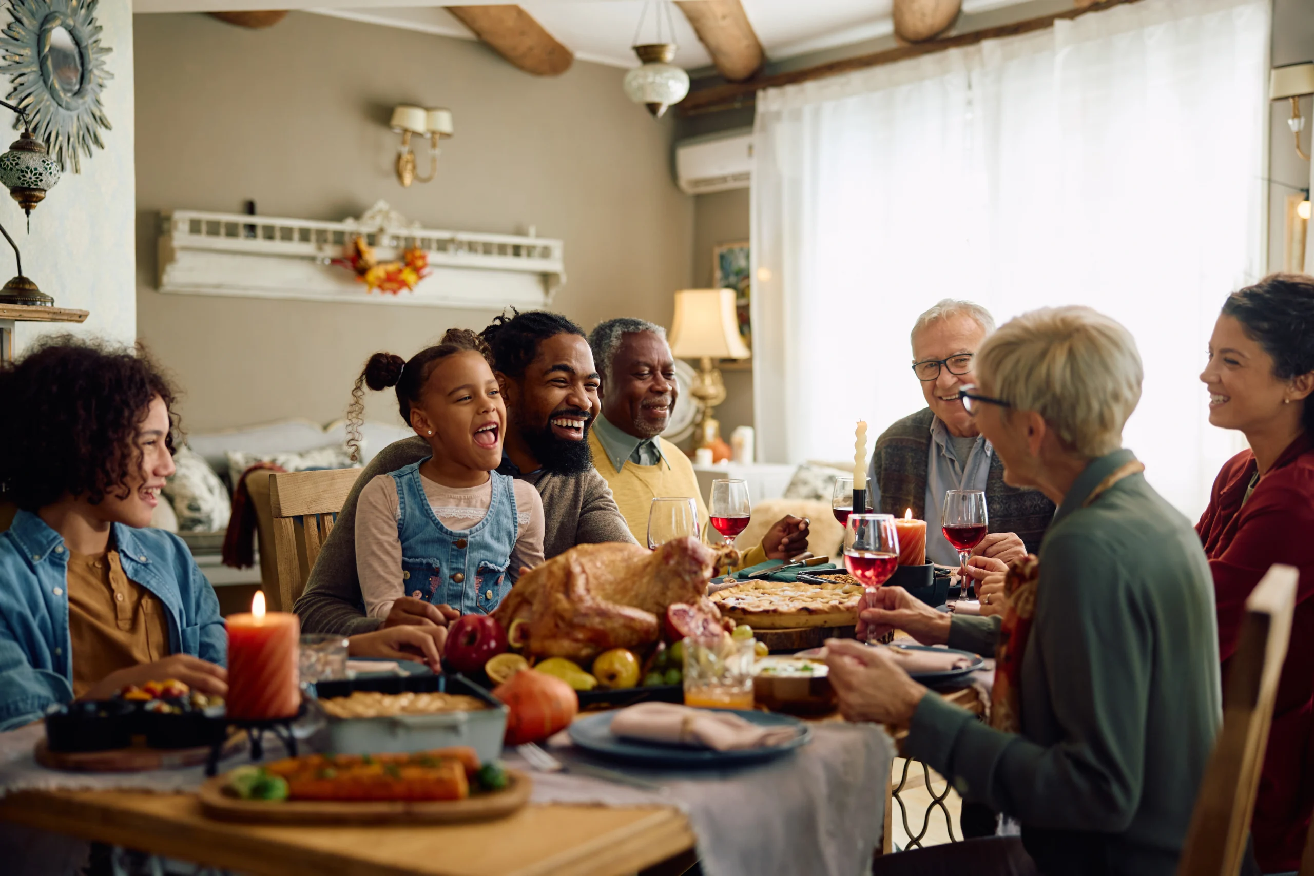 Family sitting around holiday table eating food together