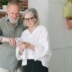 Two Elderly Individuals Looking at Phone